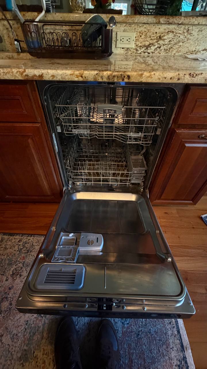 GE Profile dishwasher door open during service in a Naples kitchen