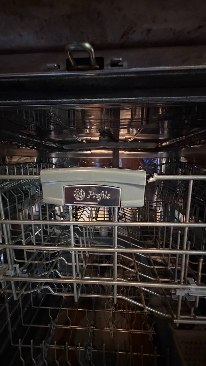 Close-up inside the GE Profile dishwasher during repair
